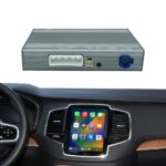 Gray automotive control module with white connector and blue power plug, mounted above a car’s touchscreen dashboard.