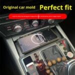 Phone resting on a wireless charger in a car center console, with gear shifter nearby and red-lit controls, showing 'Original car mold – Perfect fit' promo text.