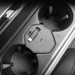 Car interior showing a hexagonal wireless charging pad and USB-C port in the center console.