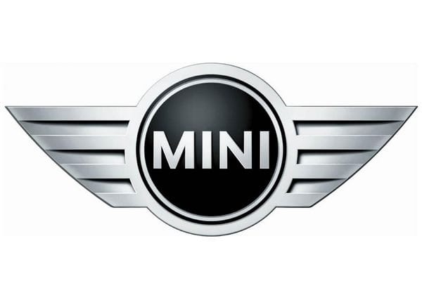 MINI logo featuring a black circular center with silver border and winged chrome wings extending outward.
