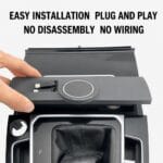 Close-up of a hand installing a plug-and-play car accessory into the center console near the gear shift, emphasizing easy installation.